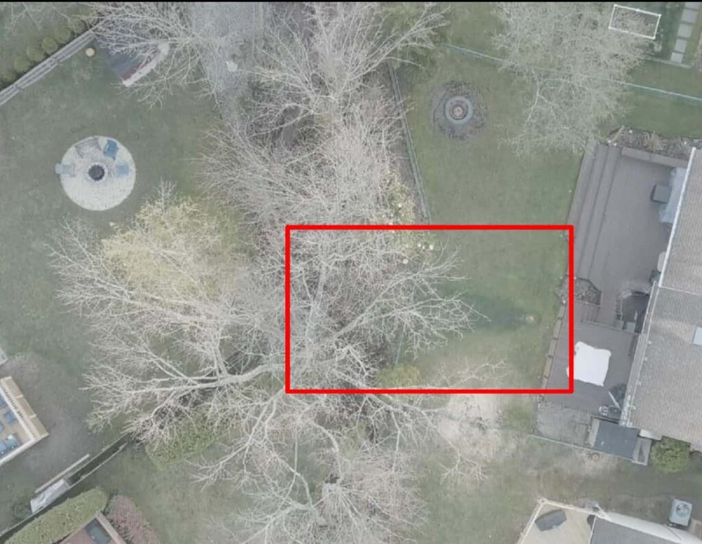 Aerial visible-light view of a courtyard with bare trees and a red box marking the area checked in thermal
