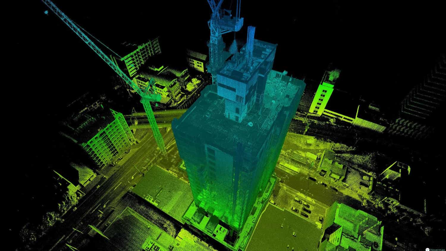 Point cloud scan of a building and tower crane under construction, colored by height