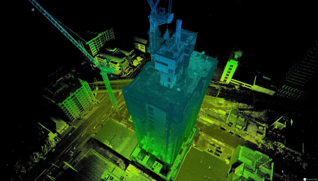 Point cloud scan of a building and tower crane under construction, colored by height